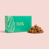 Green box with 'Palm & Vine' branding next to almonds on a pink background healthy snacking UK