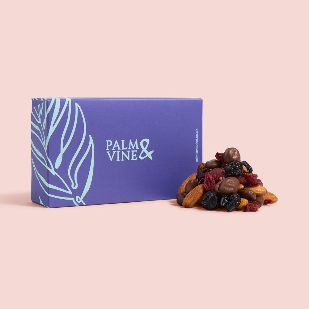 Blue box labeled 'Palm & Vine' with a pile of dried fruits on a pink background healthy snacking UK