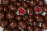Chocolate-covered raspberries with a red center on a white background