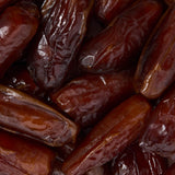Close-up of dried deglet nour dates with a dark background healthy snacking UK