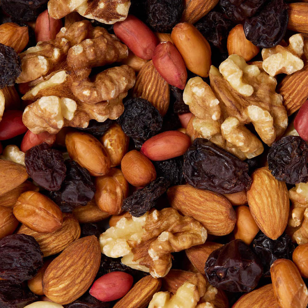 Assorted nuts and dried fruits including almonds, walnuts, and raisins healthy snacking UK