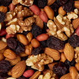 Assorted nuts and dried fruits including almonds, walnuts, and raisins healthy snacking UK