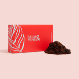 Red box with 'Palm & Vine' branding next to a pile of sultanas on a pink background healthy snacking UK
