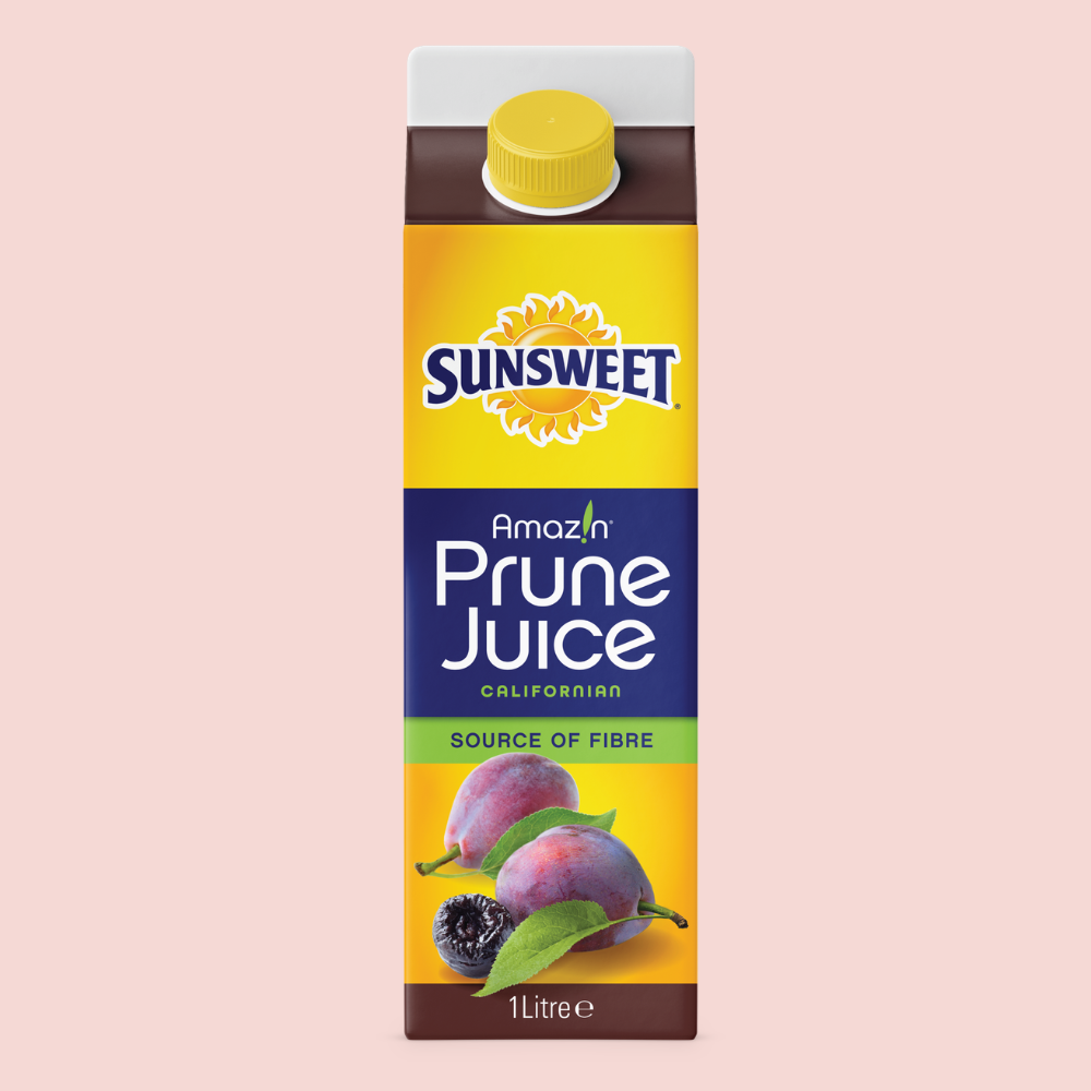 Californian prune juice in a carton on a pink background