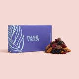 Blue box labeled 'Palm & Vine' with a pile of dried fruits on a pink background  healthy snacking UK