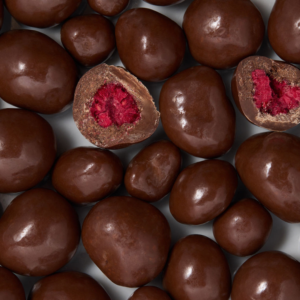 Chocolate raspberries with a red center on a white background  healthy snacking UK
