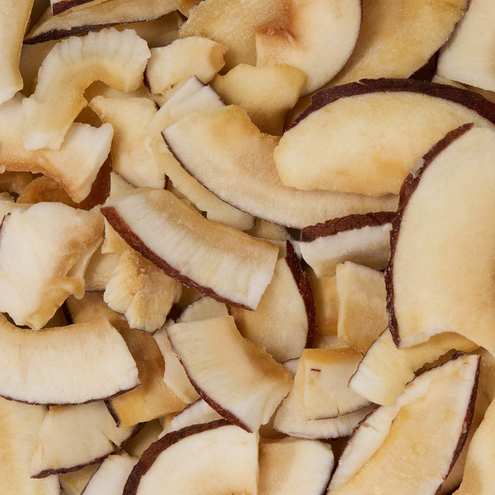 Close-up of sliced coconut pieces with brown edges healthy snacking UK