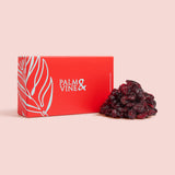 Red box with 'Palma & Vine' branding next to dried cranberries on a pink background healthy snacking UK