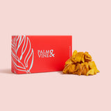 Red box with 'Palm & Vine' branding next to a pile of mango chunks on a pink background healthy snacking UK